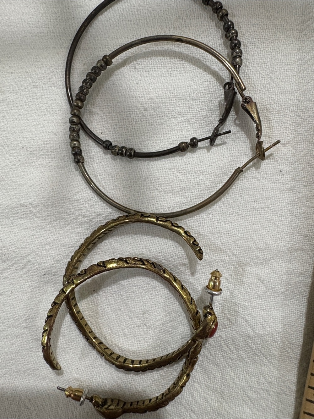 Brass-Tone snake hoop earrings and vintage beaded hoop earrings.